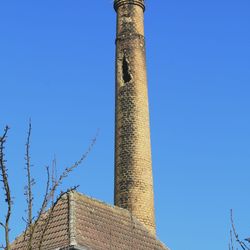 Im oberen Drittel des alten, aus roten Ziegeln gemauerten Schornsteins ist das Loch im Mauerwerk zu erkennen. Foto: C. Schneider
